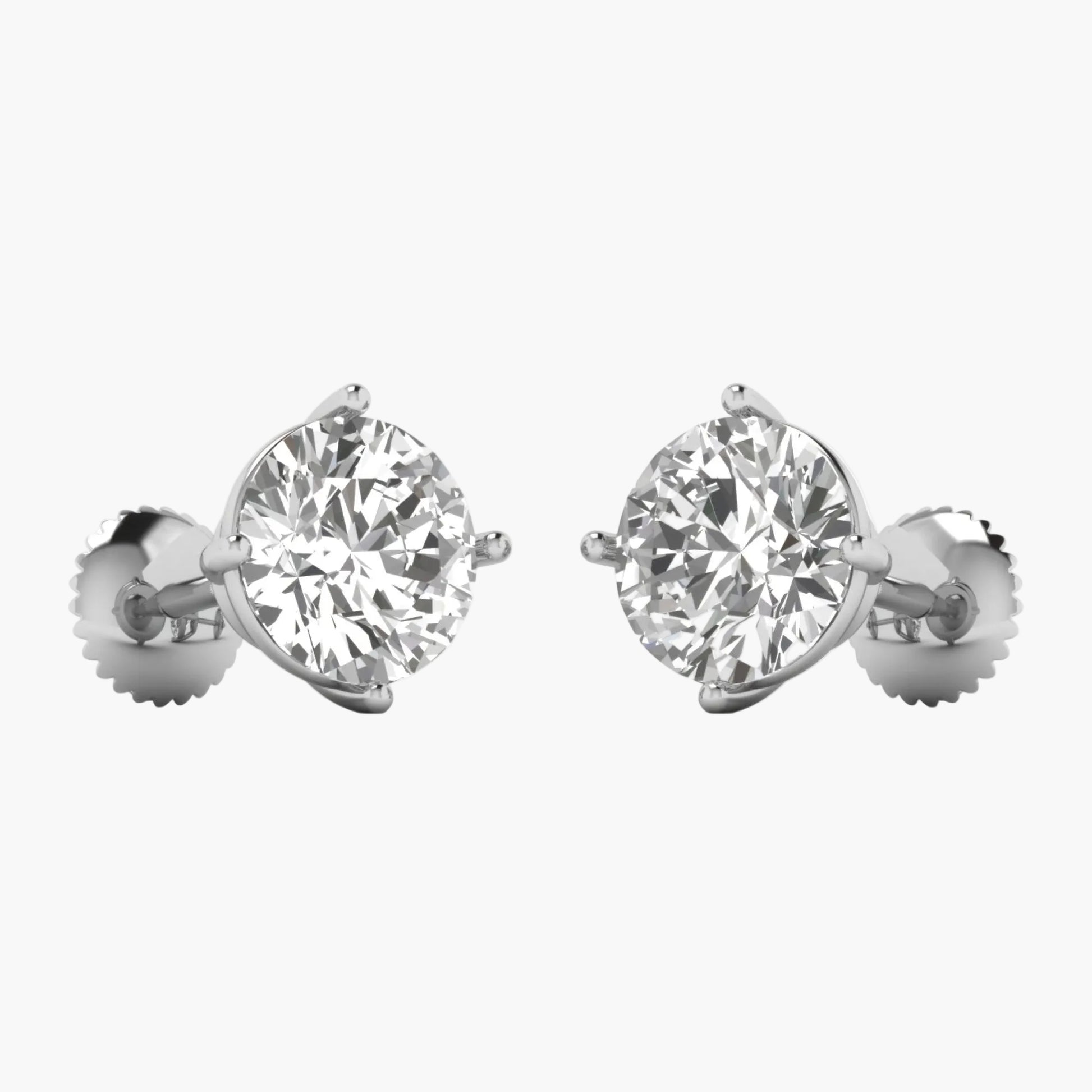 Pair of diamond stud earrings on a white background
