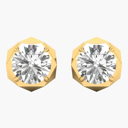 Gold earrings with round gemstones on a white background