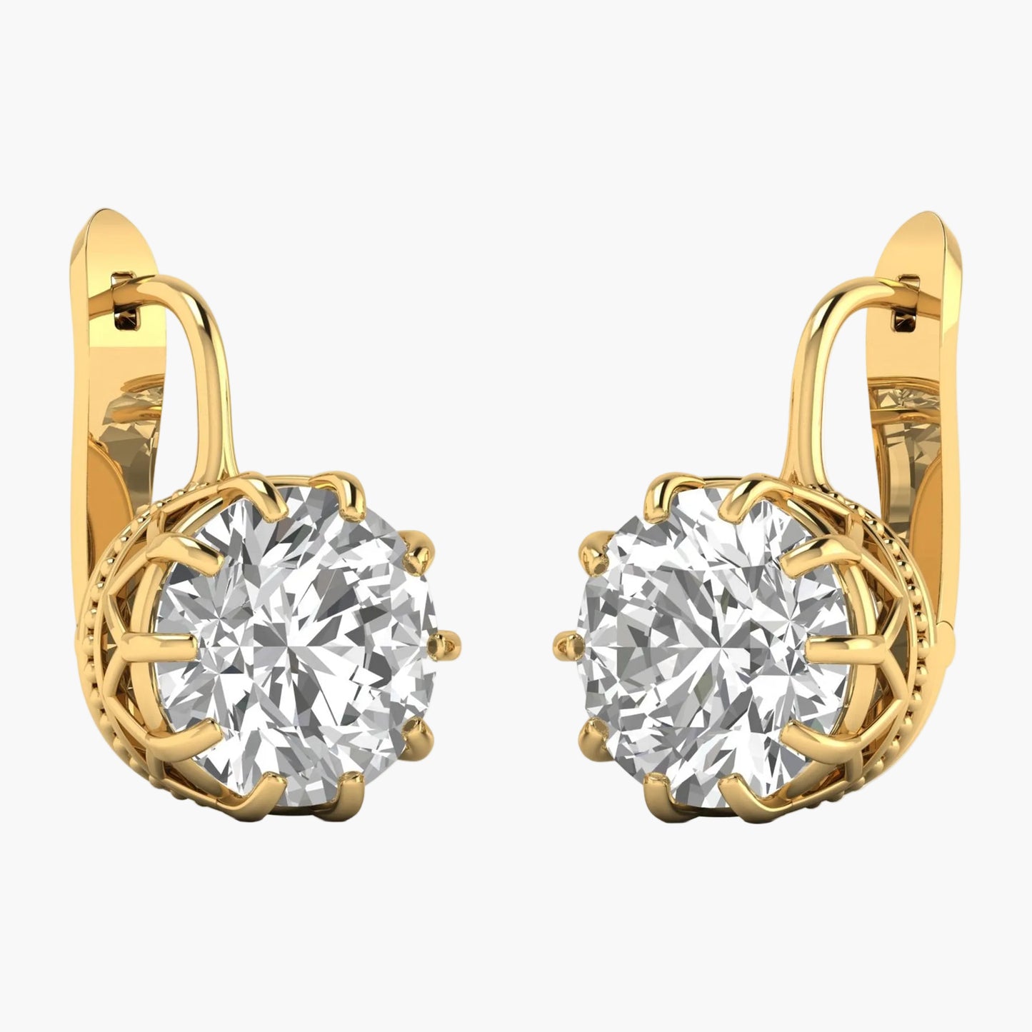 Gold earrings with large clear gemstones on a white background