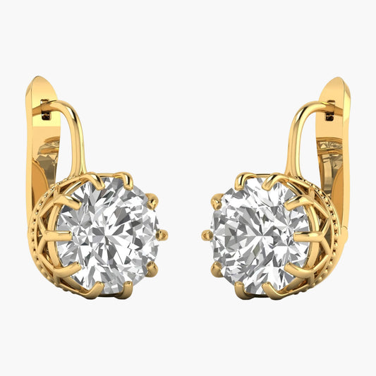 Gold earrings with large clear gemstones on a white background