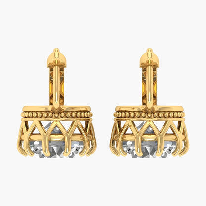 Gold earrings with crystal elements on a white background