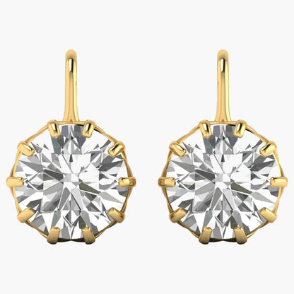 Gold earrings with large round gemstones on a white background