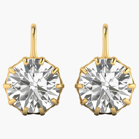 Gold earrings with large round gemstones on a white background
