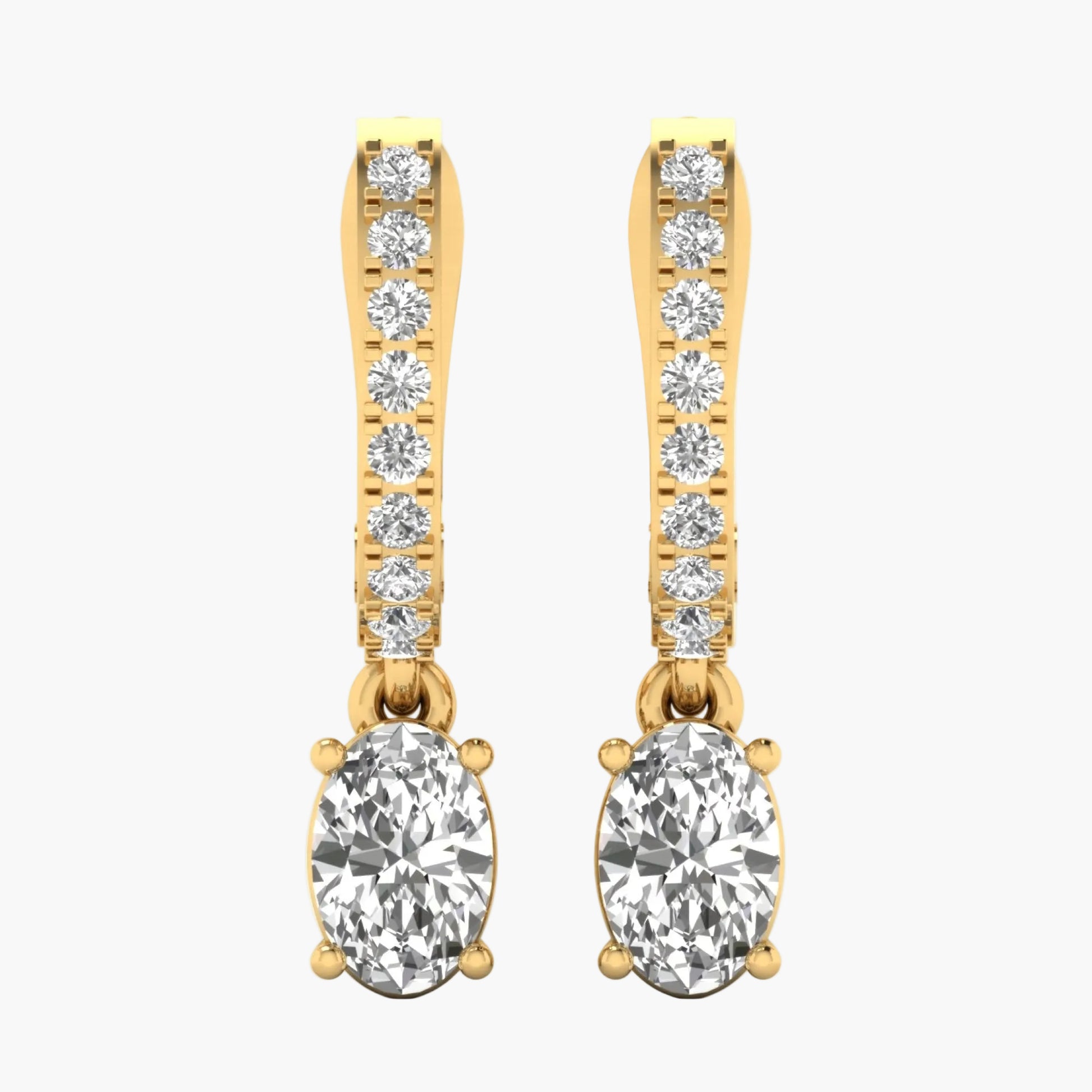 Gold earrings with clear gemstones on a white background