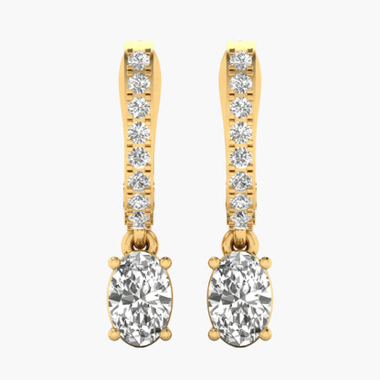 Gold earrings with clear gemstones on a white background