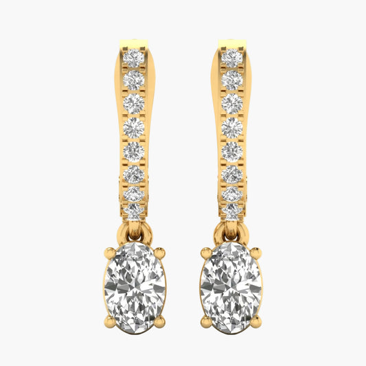 Gold earrings with clear gemstones on a white background