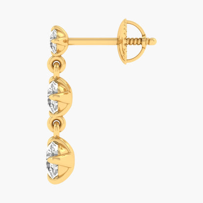Gold earring with three clear gemstones on a white background