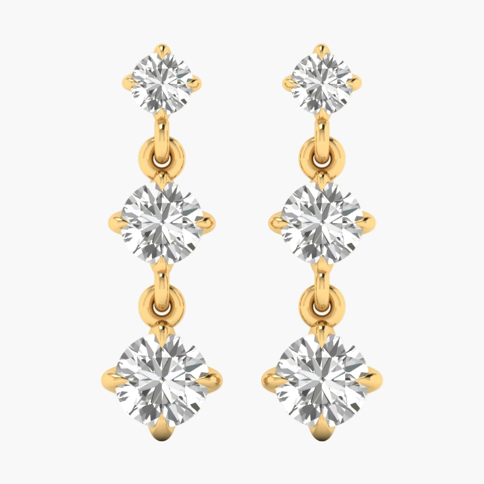 Gold and silver earrings with clear gemstones on a white background