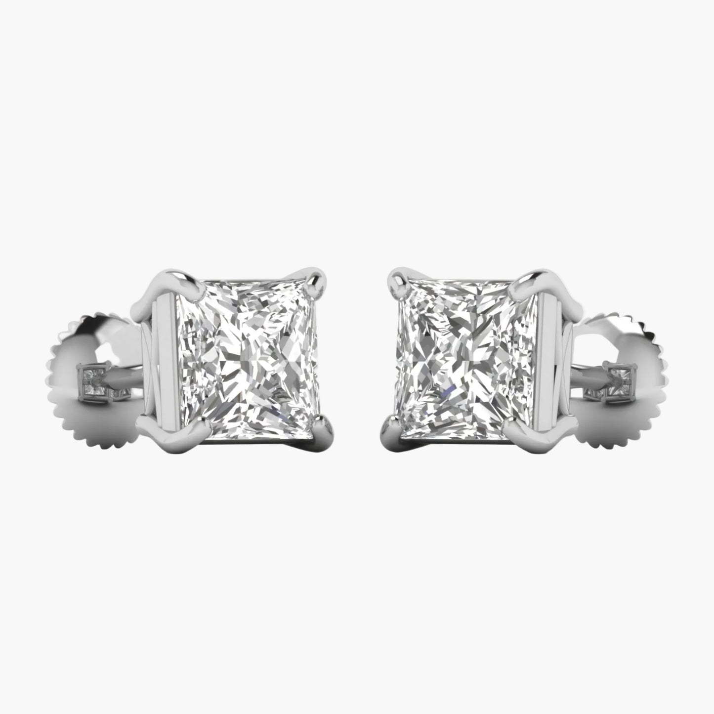 Pair of diamond stud earrings on a white background