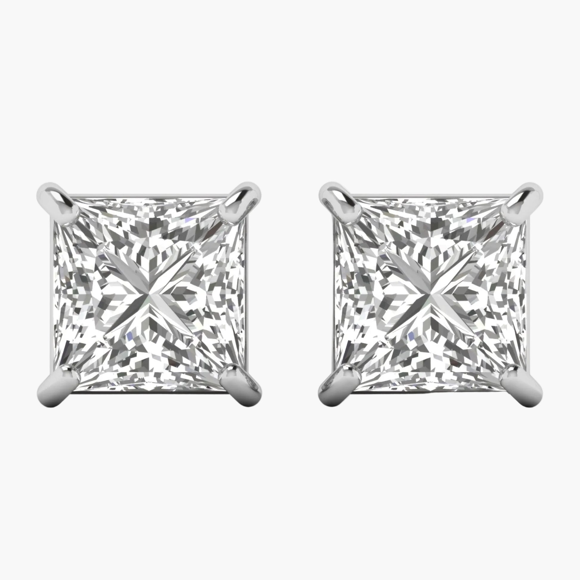 Pair of diamond stud earrings on a white background