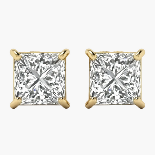 A pair of princess-cut diamond stud earrings in yellow gold four-prong settings, shown against a clean white background.