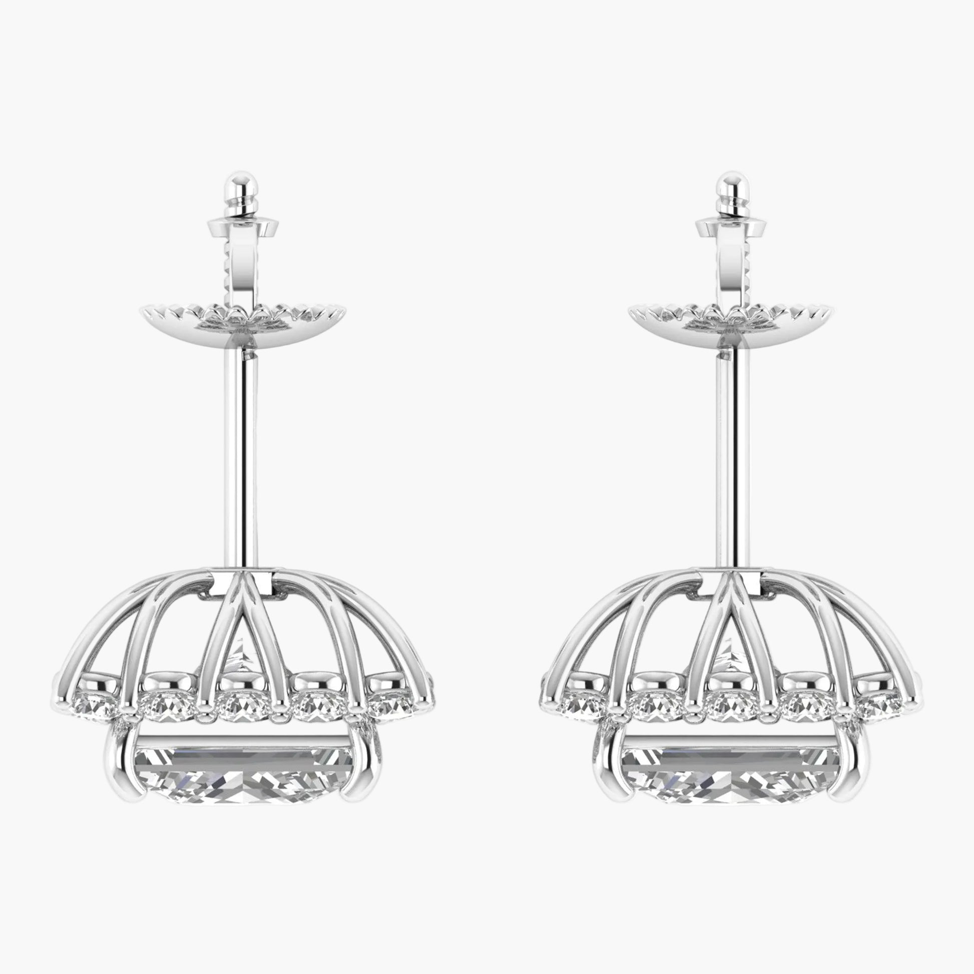 Pair of silver earrings with intricate designs on a white background