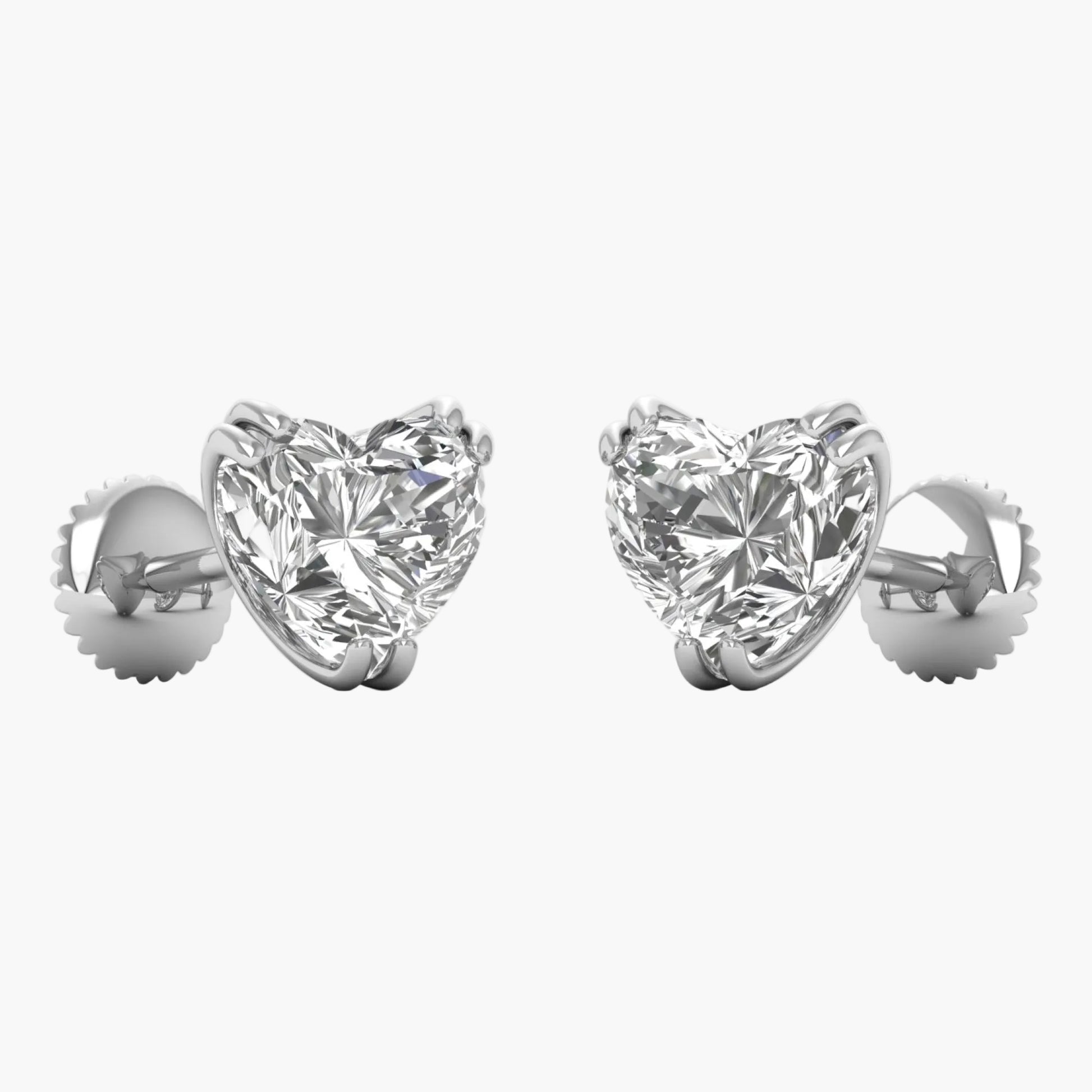 Heart-shaped diamond earrings on a white background