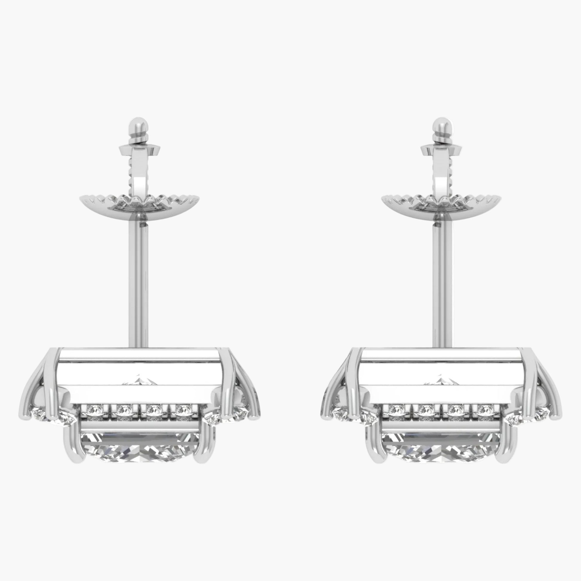 Pair of silver earrings with intricate designs on a white background