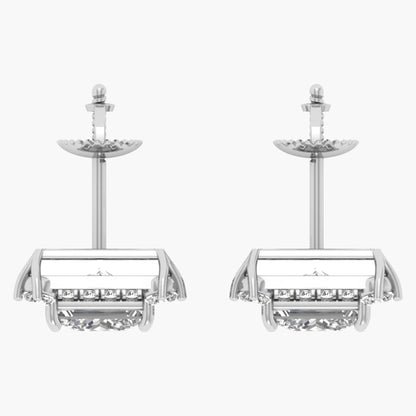 Pair of silver earrings with intricate designs on a white background