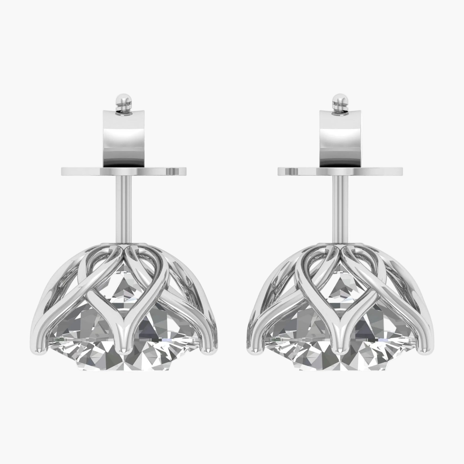 Pair of silver earrings with intricate designs on a white background