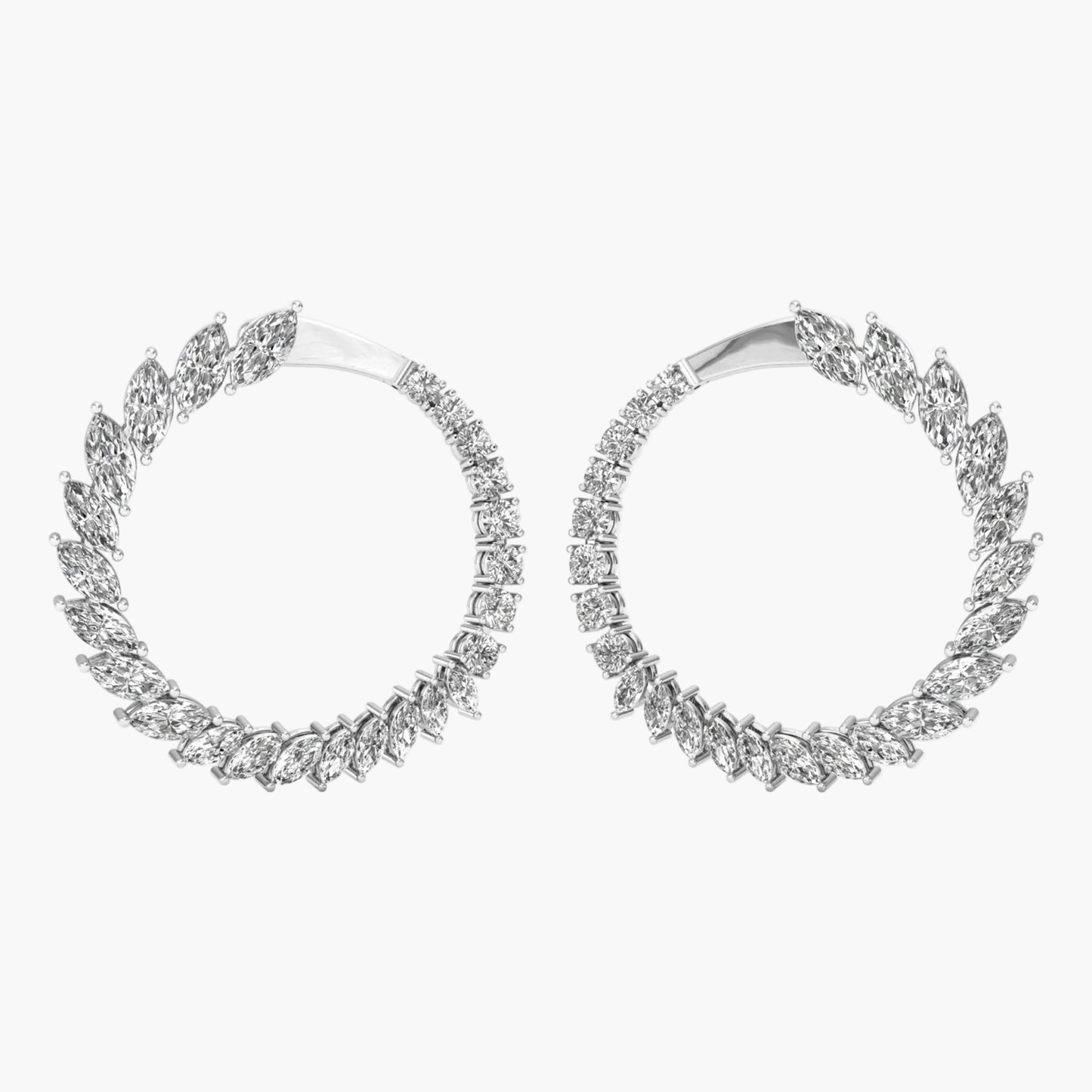 Pair of silver hoop earrings with diamond-like stones on a white background