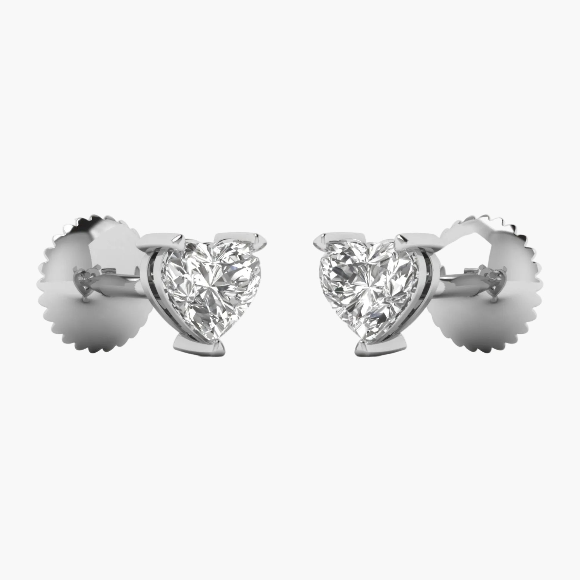 Heart-shaped diamond earrings on a white background