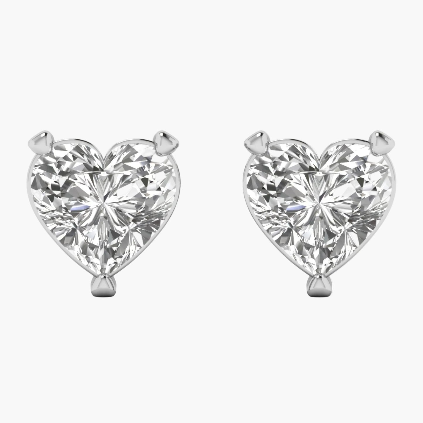 Heart-shaped diamond earrings on a white background