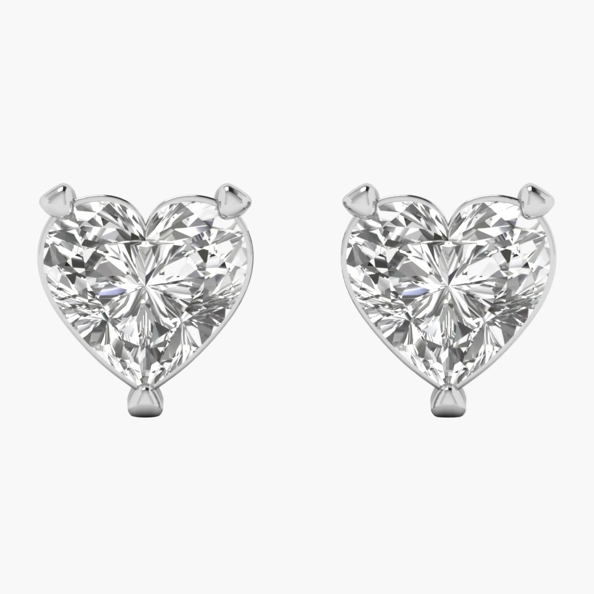 Heart-shaped diamond earrings on a white background