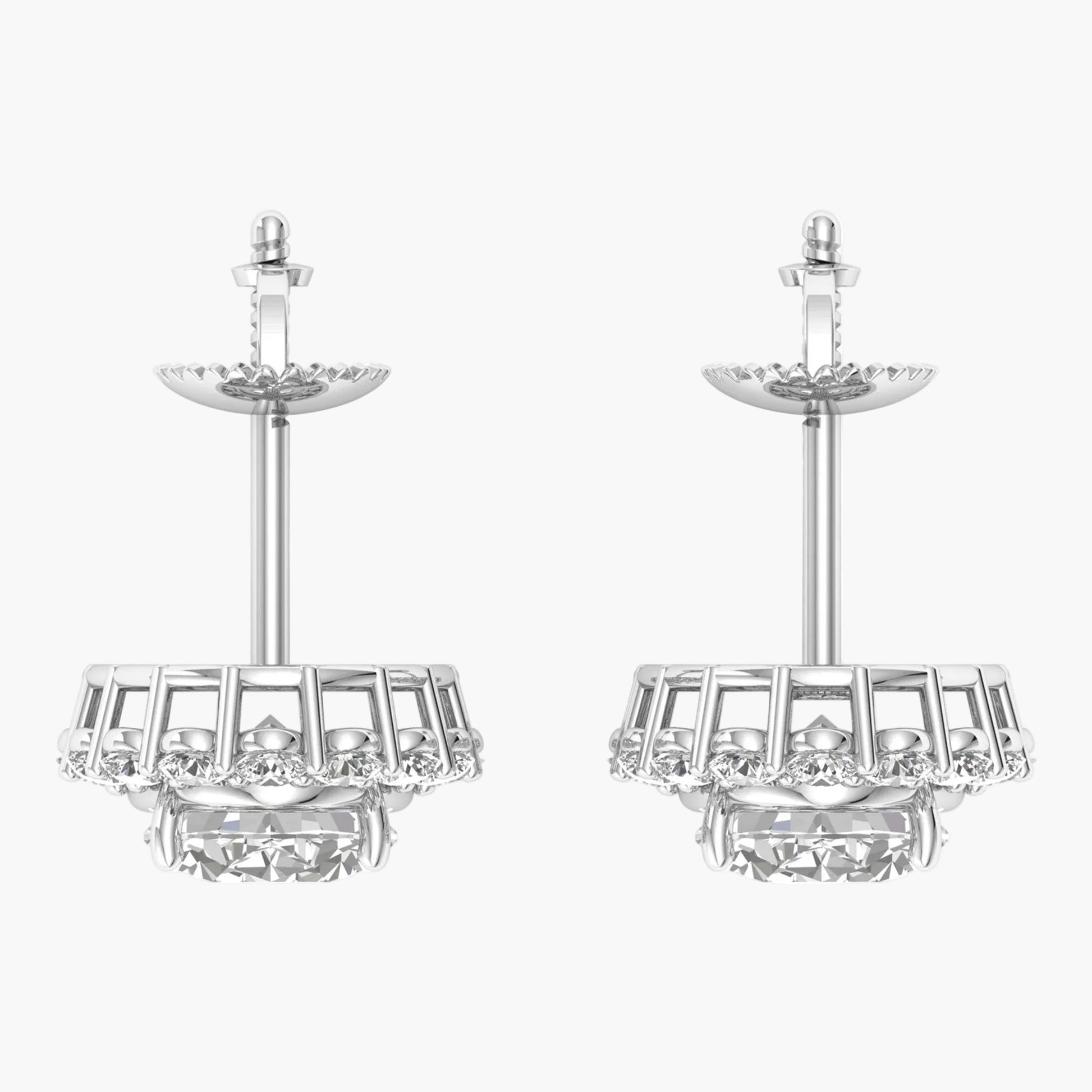 Pair of silver earrings with intricate designs on a white background