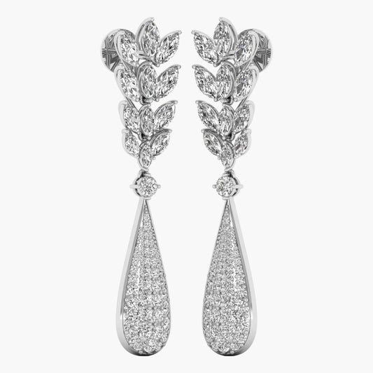 Pair of silver leaf-shaped earrings with teardrop designs on a white background