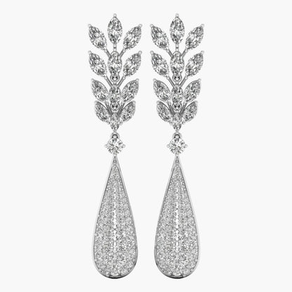 Pair of silver earrings with teardrop design and leaf-like top on a white background