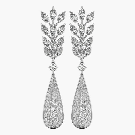 Pair of silver earrings with teardrop design and leaf-like top on a white background
