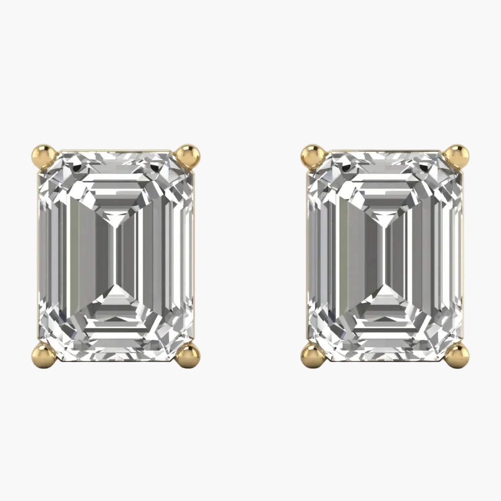 Pair of diamond earrings with gold prongs on a white background