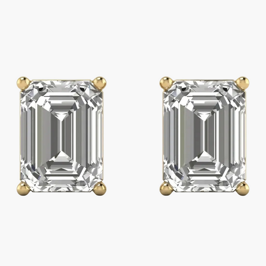 Pair of diamond earrings with gold prongs on a white background