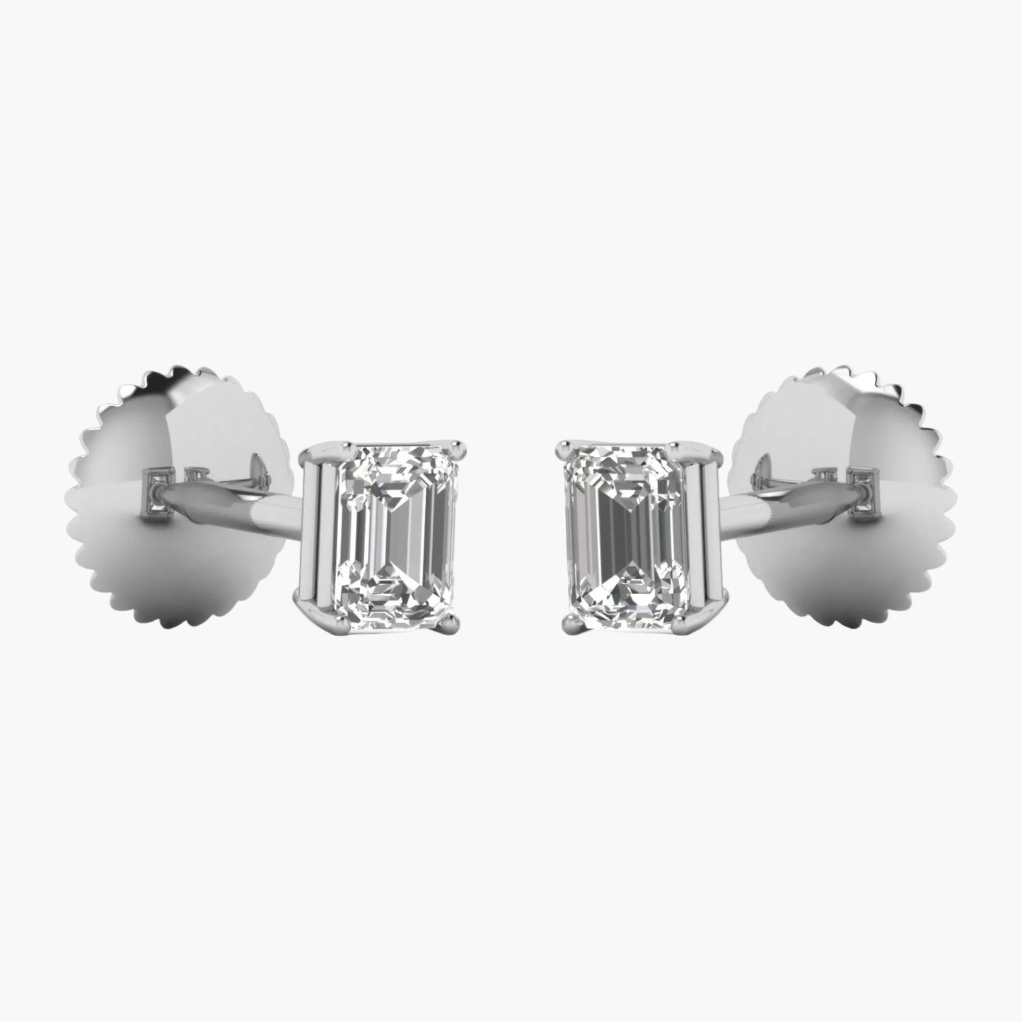 Diamond earrings with emerald-cut stones on a white background