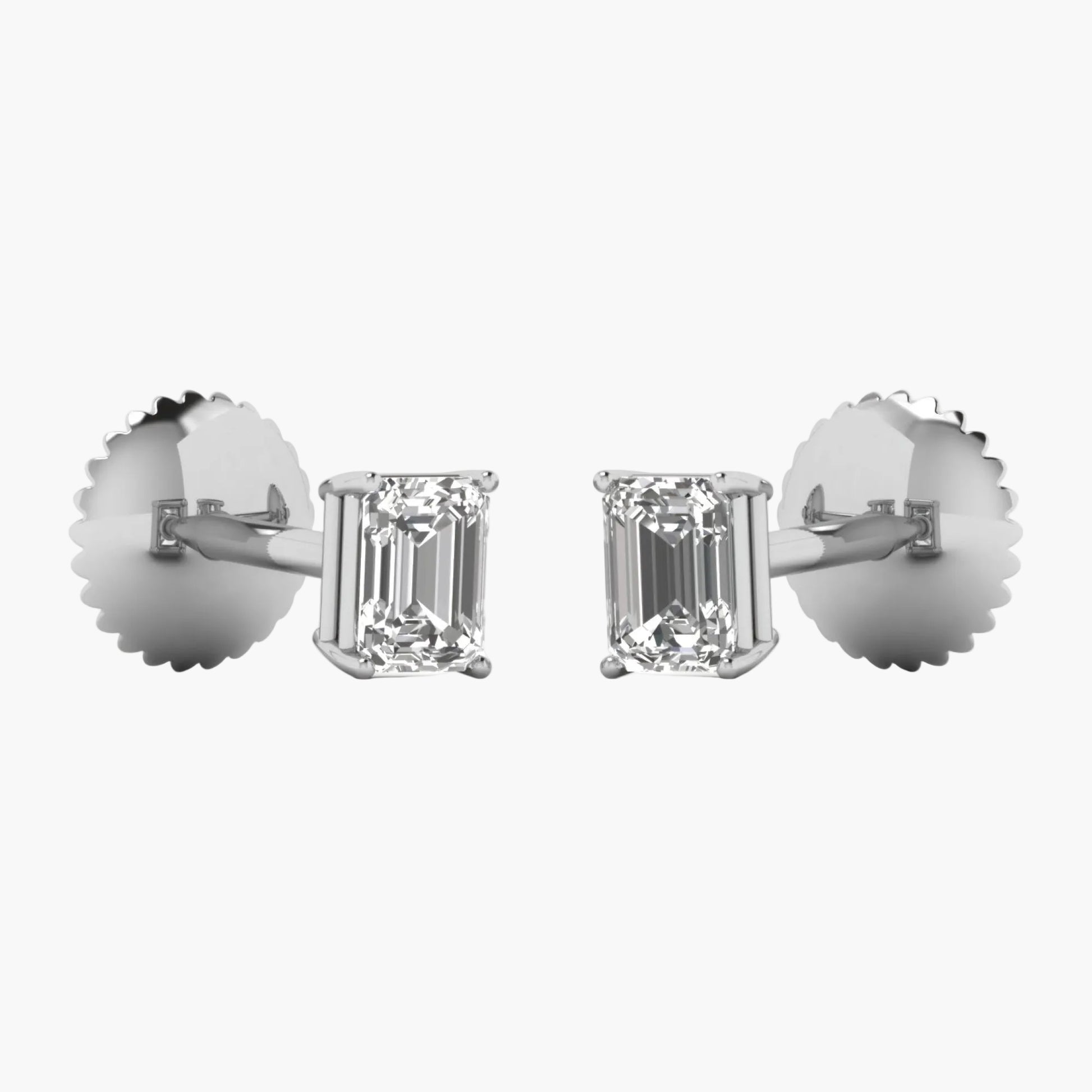 Diamond earrings with emerald-cut stones on a white background