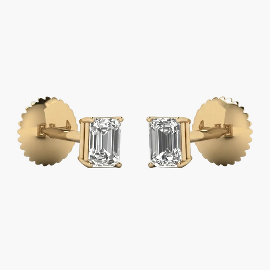 Gold earrings with emerald-cut diamonds on a white background