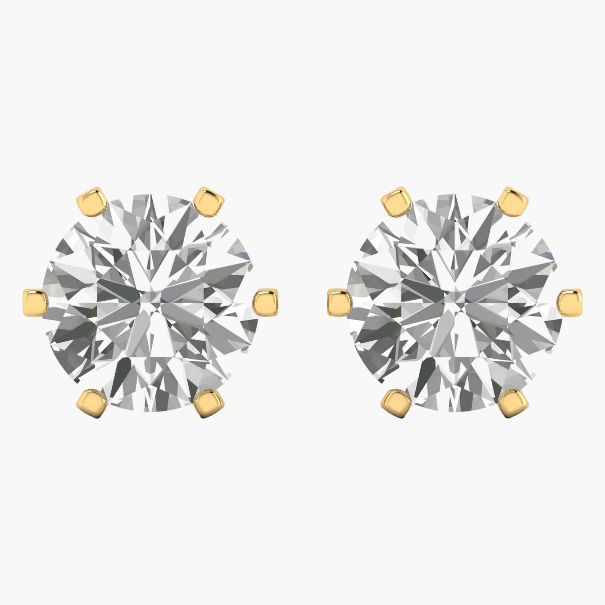 Pair of diamond stud earrings with gold prongs on a white background