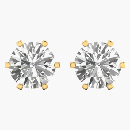 Pair of diamond stud earrings with gold prongs on a white background