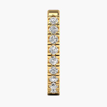 Gold earring with diamonds on a white background