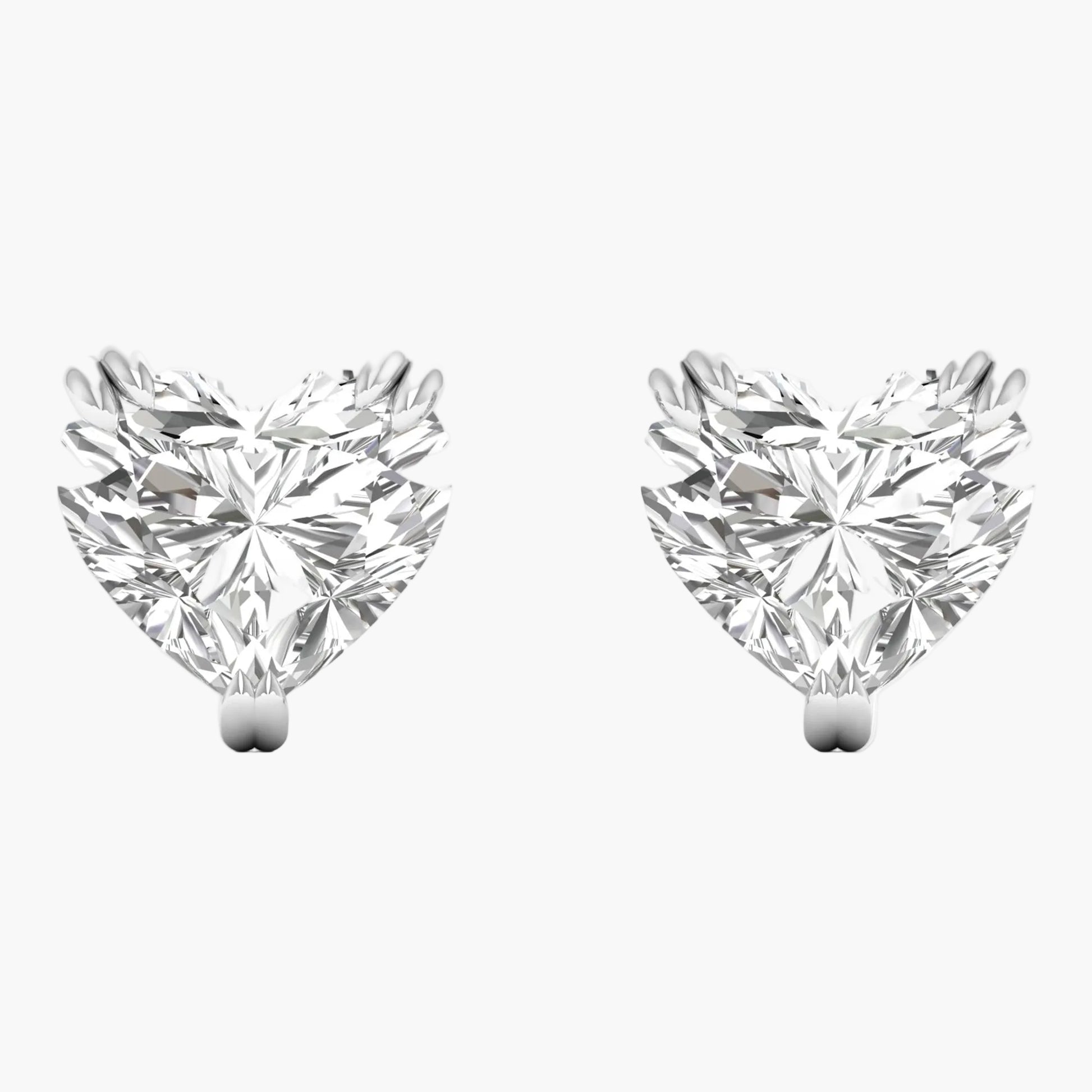 Pair of heart-shaped diamond earrings on a white background