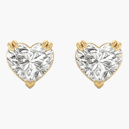 Heart-shaped diamond earrings with gold prongs on a white background