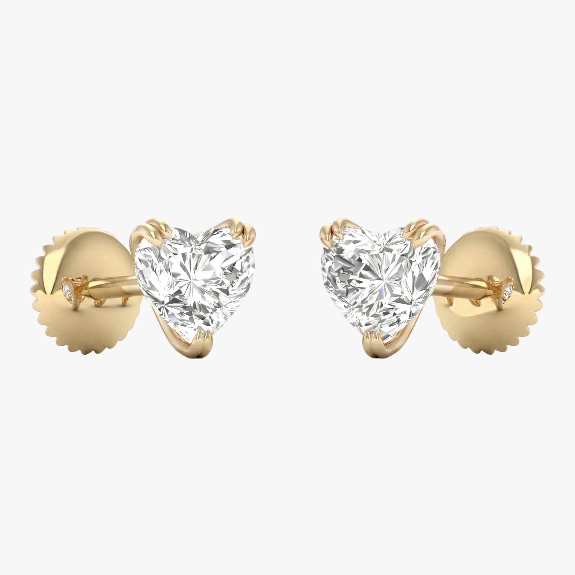 Heart-shaped diamond earrings with gold settings on a white background