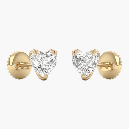 Heart-shaped diamond earrings with gold settings on a white background