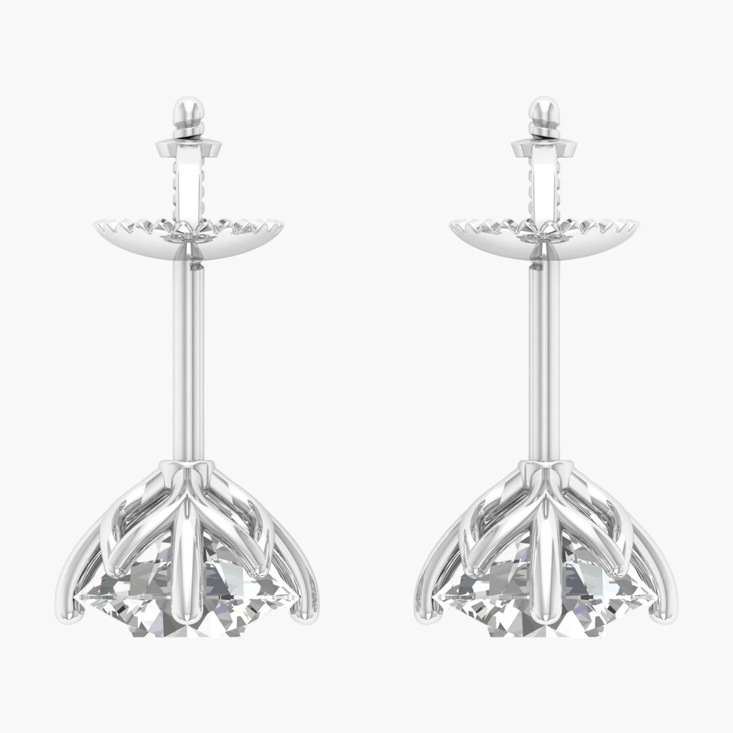 Pair of silver earrings with intricate designs on a white background