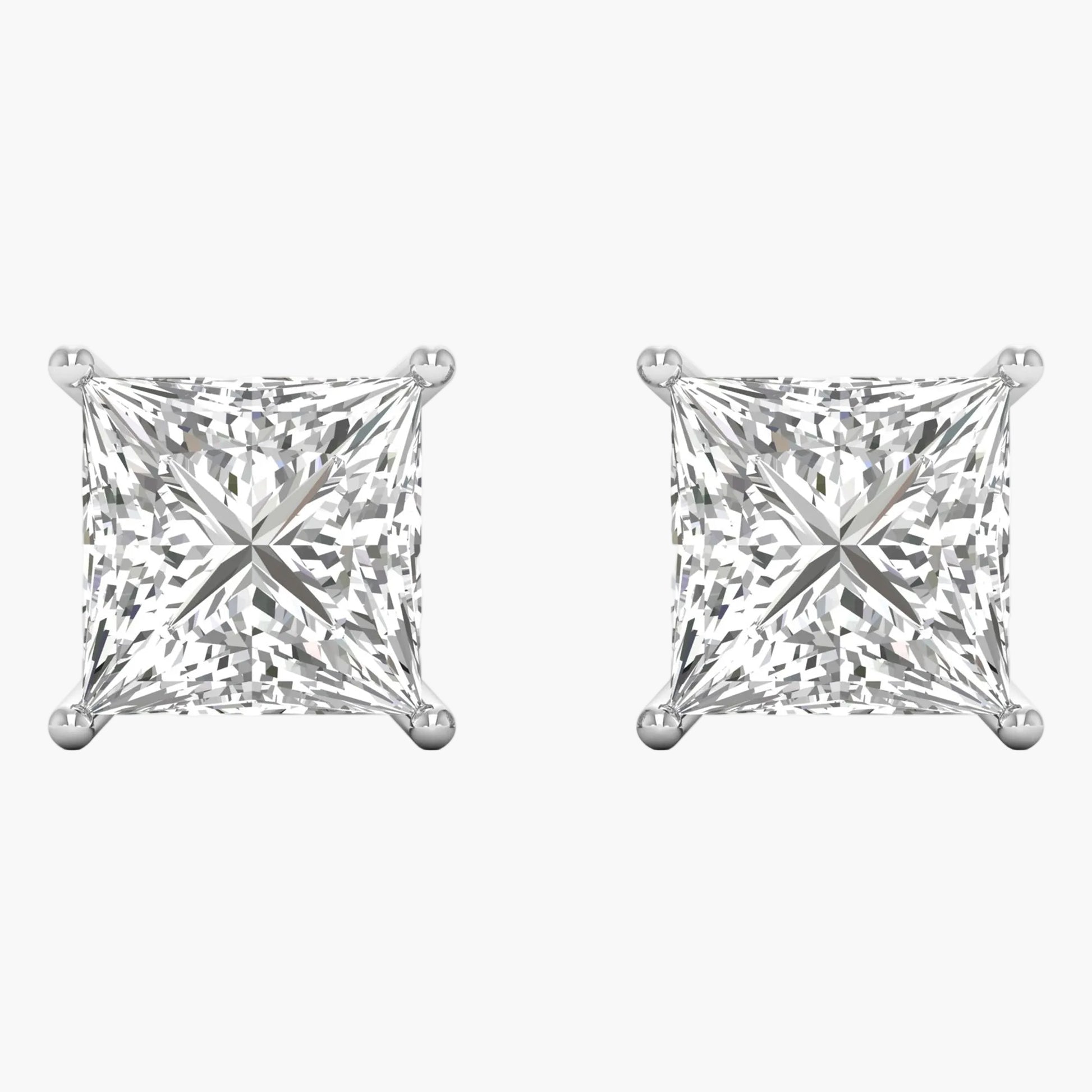Pair of diamond stud earrings on a white background
