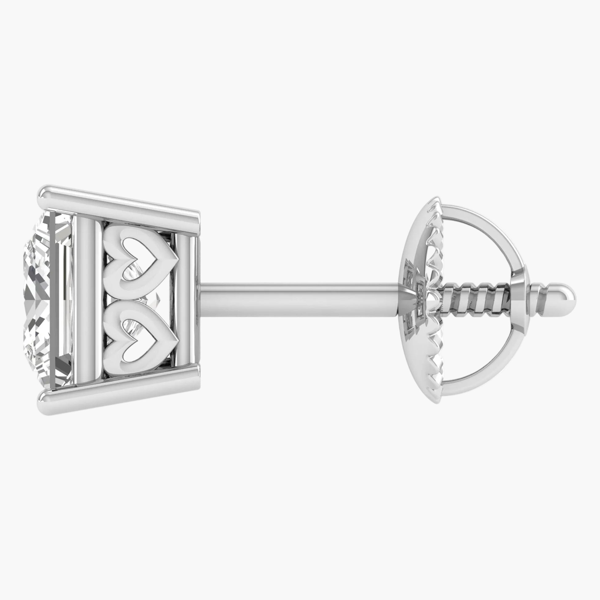 Silver earring with heart design on a white background