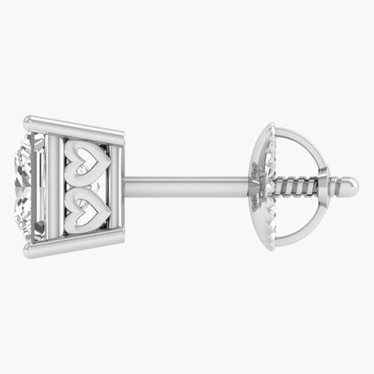 Silver earring with heart design on a white background