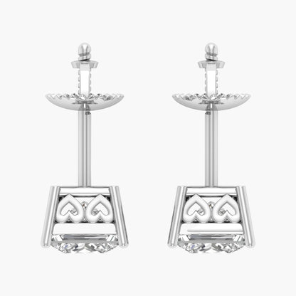 Pair of silver earrings with intricate designs on a white background