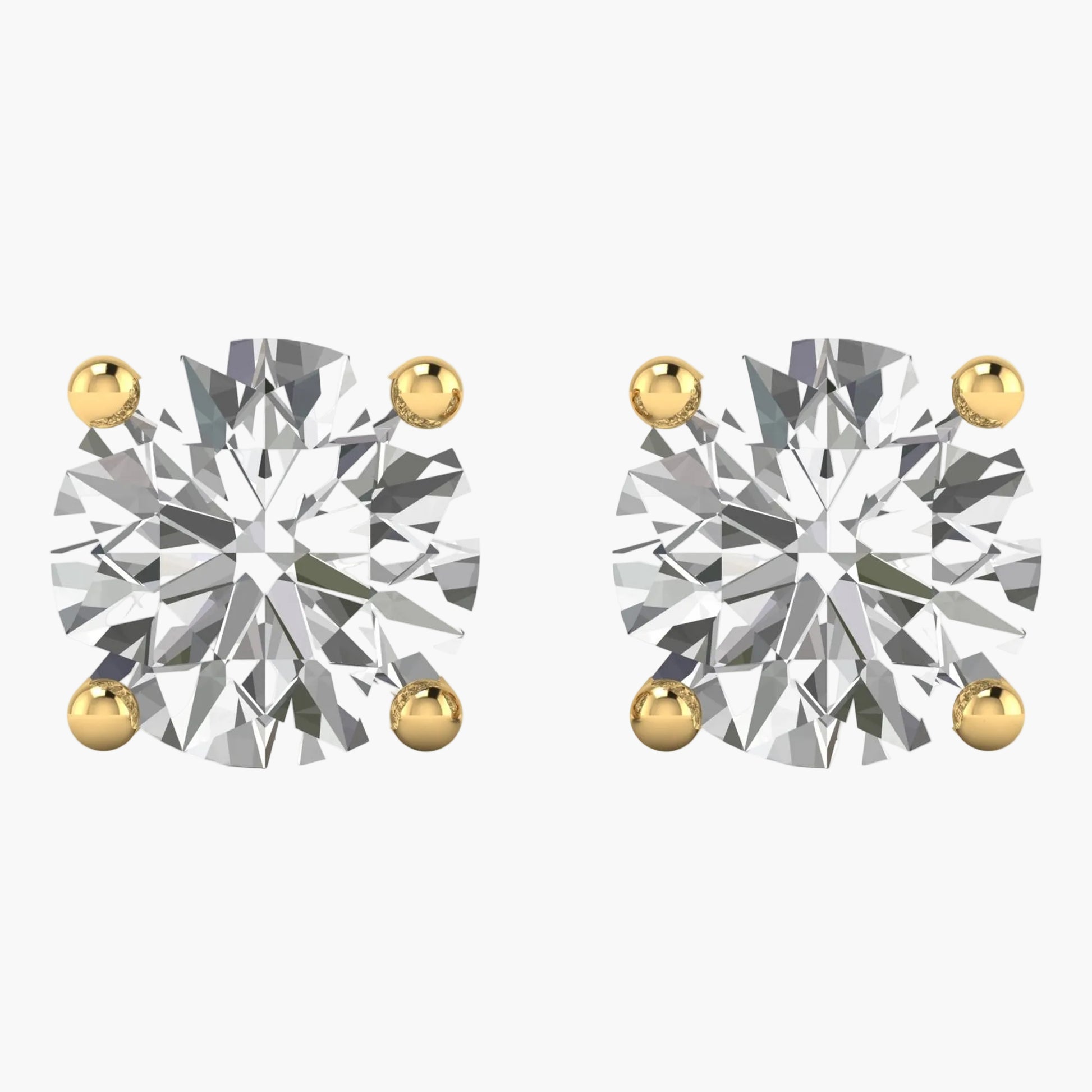 Pair of diamond stud earrings with gold prongs on a white background