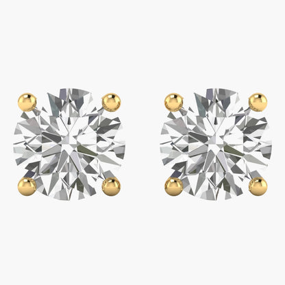 Pair of diamond stud earrings with gold prongs on a white background