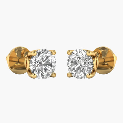 Gold earrings with clear gemstones on a white background