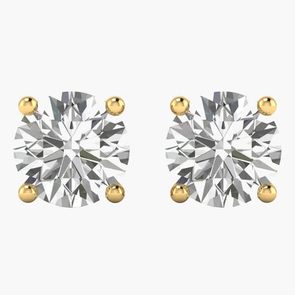 Pair of diamond stud earrings with gold prongs on a white background