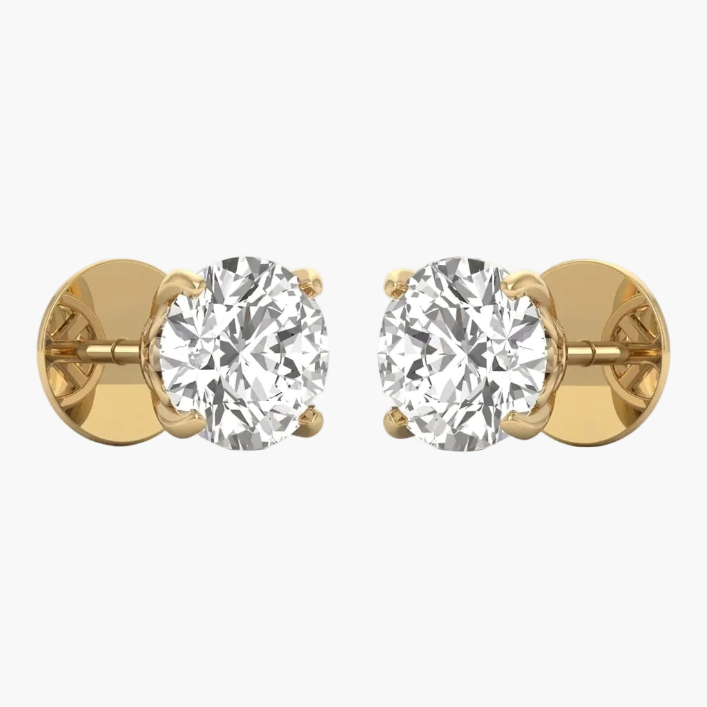 Gold earrings with clear gemstones on a white background